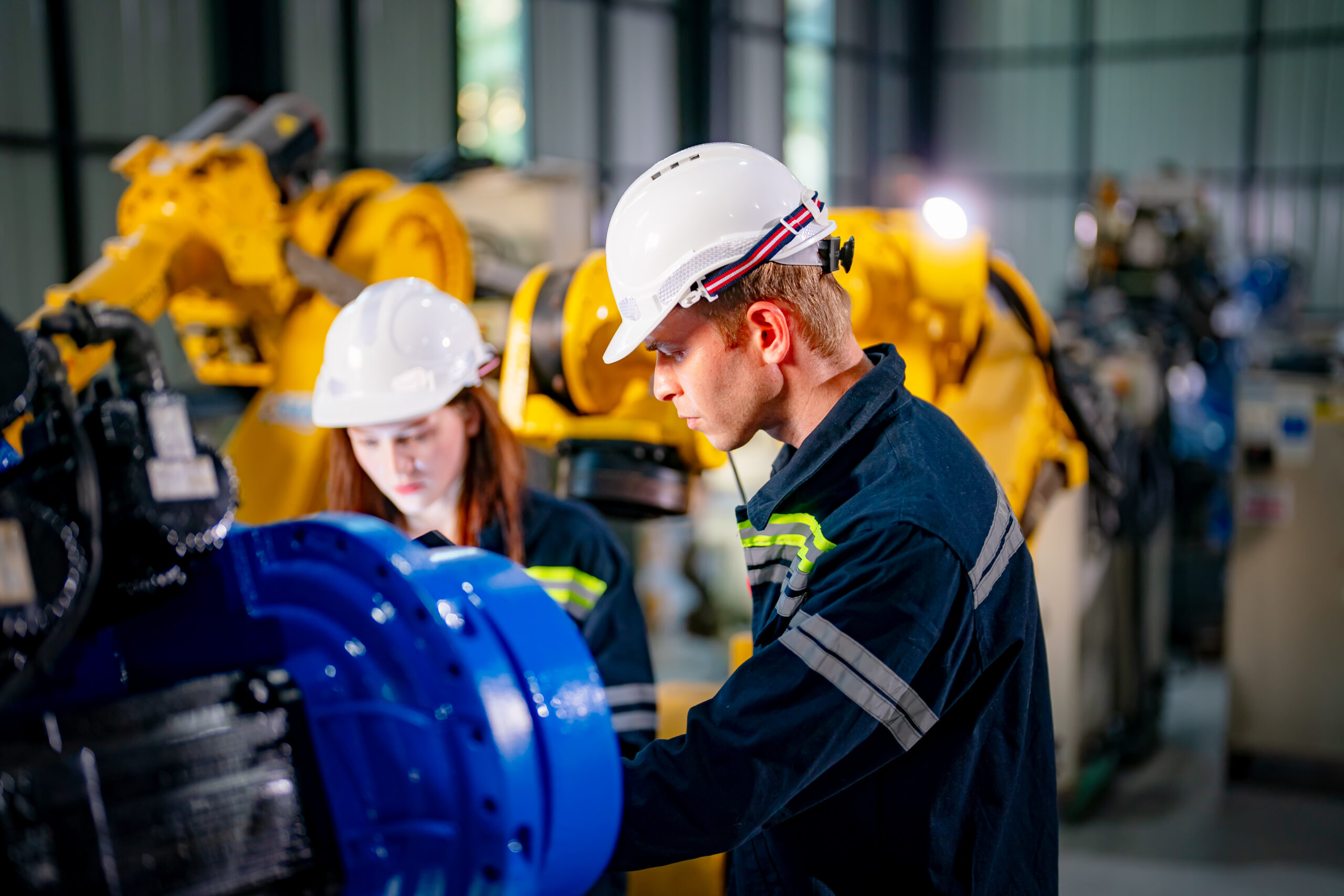 Indusrtial Robot, Engineers inspecting and check up welding robots at factory.